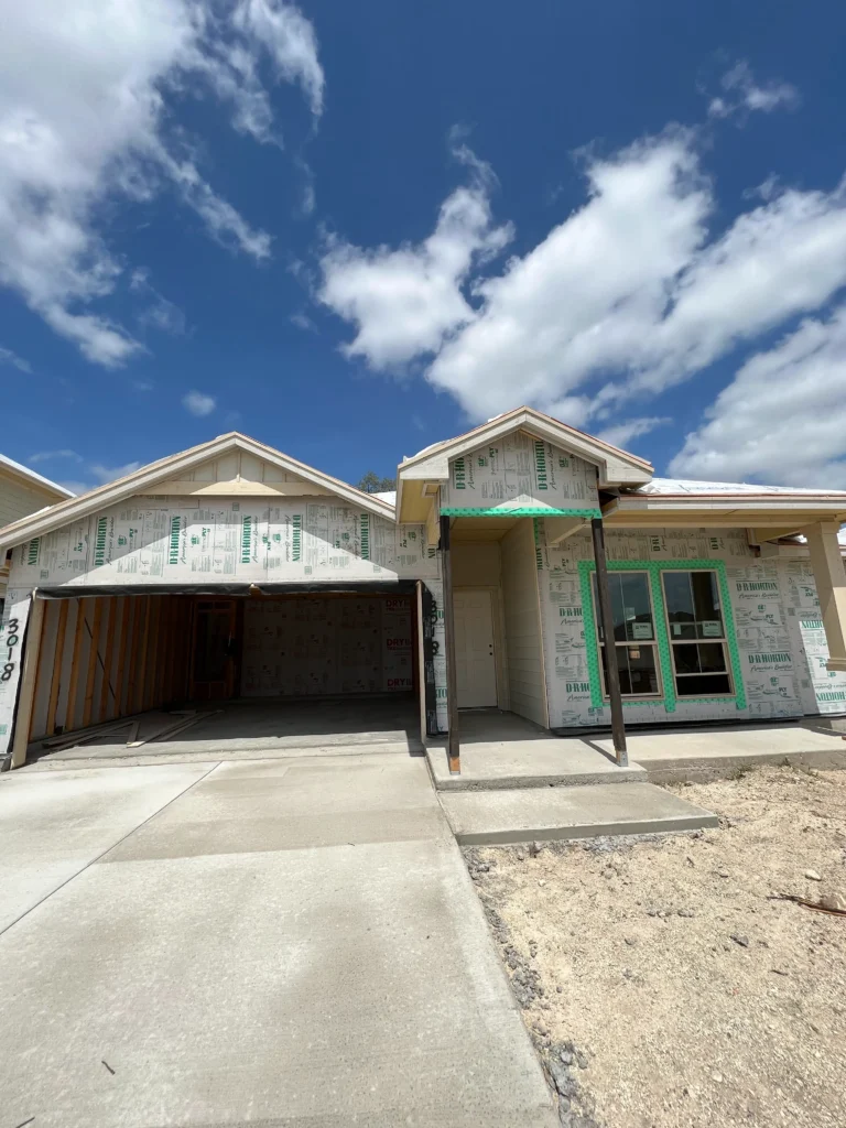 New house under construction, cloudy sky